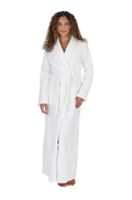 Long white waffle-textured bathrobe with shawl collar, wrap belt, and long sleeves