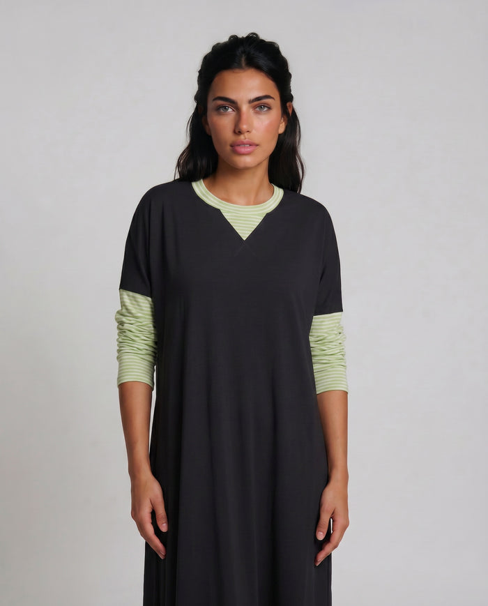 Black pull on nightgown with contrasting  light green long sleeves and neck trim.