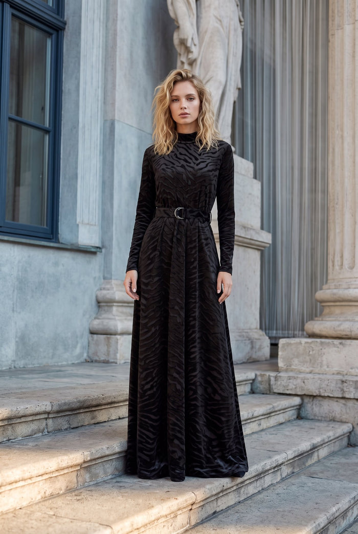 Black patterned velvet long sleeve maxi dress with mock turtle neck collar and metal loop self belt.