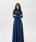 Blue patterned velvet long sleeve maxi dress with mock turtle neck collar and metal loop self belt.
