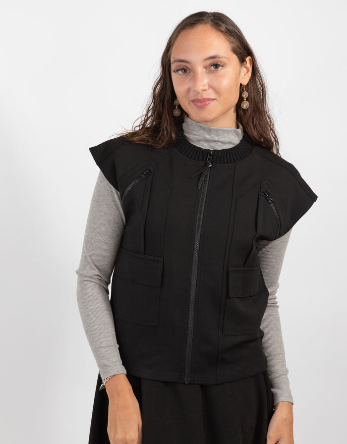 Black zip-front vest with ribbed collar and chest pocket, utility-style side pockets.